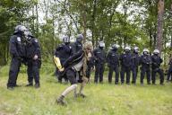 Democlown jokes in front of a police line at the demonstration Wasser. Forest. Justice against the expansion of the Tesla Gigafactory in Grünheide near Berlin, 11.05