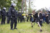 Police and Democlown face each other at the demonstration Wasser. Forest. Justice against the expansion of the Tesla Gigafactory in Grünheide near Berlin, 11.05