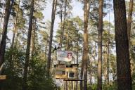 Two people swing above a tree house in the occupied section of the Tesla Stop forest. The occupation of the forest is intended to demonstrate against the imminent clearing for the planned expansion of the Tesla Gigafactory in Grünheide. 11.05