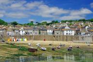 Beach with boats lying on a sandy beach, Mousehole, Cornwall, Great