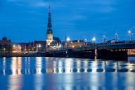 St Peters Church and stone bridge in the morning at the blue hour, River Daugava, Riga, Latvia