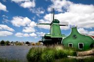 Green windmill over blue sky in Zaanse