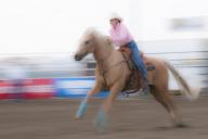 Motion blur of a cowgirl riding fast during barrel racing, Strathmore Heritage Days, Rodeo, Strathmore, Alberta, Canada, North