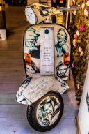 Artistic showcase with Vespa, Taormina on a rock terrace on the slope of Monte Tauro, Taormina, Sicily, Italy