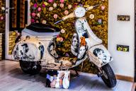 Artistic showcase with Vespa, Taormina on a rock terrace on the slope of Monte Tauro, Taormina, Sicily, Italy
