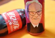 A can of Cherry Coca-Cola with a portrait of Warren Buffett, Chairman and CEO of Berkshire Hathaway, is pictured on the shelf with other soft drinks at a supermarket in Shenzhen city, south China