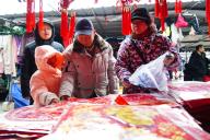 People shop Spring Festival decorations at a market in Beijing, China, 30 January, 2024