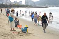 Tourists enjoy vacation in Sanya City, southernmost China