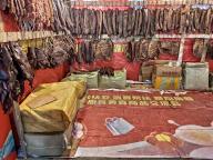 People shop cured meat for Spring Festival at a market in Chongqing, China, 30 January, 2024