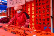 People buy handwritten Chunlian, or spring couplets in Foshan City, south China