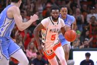 CORAL GABLES, FL - FEBRUARY 10: Miami guard Wooga Poplar (5) drives to the basket while followed by North Carolina forward/center Armando Bacot (5) in the first half as the Miami Hurricanes faced the North Carolina Tar Heels on February 10, 2024, at the Watsco Center in Coral Gables, Florida. (Photo by Samuel Lewis/Icon Sportswire