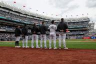BRONX, NY - APRIL 21: Members of the New York Yankees stand for the national anthem prior to a regular season game between the Tampa Bay Rays and New York Yankees on April 21, 2024 at Yankee Stadium in the Bronx, New York. (Photo by Brandon Sloter\/Icon Sportswire