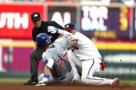 ATLANTA, GA - MAY 15: Chicago Cubs right fielder Seiya Suzuki (27) slides into 2nd base while Atlanta Braves shortstop Orlando Arcia (11) attempts to field the throw during the MLB game between the Chicago Cubs and the Atlanta Braves on May 15, 2024 at TRUIST Park in Atlanta, GA. (Photo by Jeff Robinson/Icon Sportswire