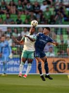 AUSTIN, TX - May 18: Austin FC midfielder Jhojan Valencia (5) and Sporting Kansas City defender Alan Pulido (right) battle for a header during game between Sporting Kansas City and Austin FC on May 18, 2024 at Q2 Stadium in Austin, TX. (Photo by John Rivera/Icon Sportswire