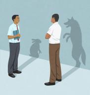 Businessmen with rabbit and wolf shadows