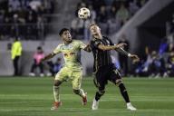 LAFC midfielder Mateusz Bogusz (19) and New York Red Bulls midfielder Frankie Amaya (8) battle for possession during a MLS match, Saturday, April 20, 2024, at the BMO Stadium, in Los Angeles, CA. LAFC tied the Red Bulls 2-2. (Jon Endow/Image of Sport