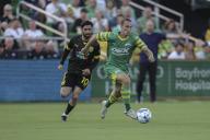 St. Petersburg, FL: Tampa Bay Rowdies forward Cal Jennings (26) dribbles the ball up the pitch while covered by New Mexico United midfielder Marco Micaletto (10) during a USL soccer game, Saturday, April 27, 2024, at Al Lang Stadium. The Rowdies defeated the United 3-0. (Kim Hukari/Image of Sport