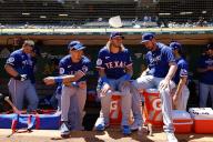 Members of the Texas Rangers sit outside the dugout prior to a game against the Oakland Athletics at Oakland Coliseum on May 8, 2024, in Oakland, California. (Photo by Brandon Sloter/Image Of Sport