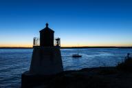 Boat passing Castle Hill Lighthouse, Newport, Rhode Island, USA