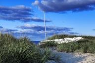 Sailboat stored in the dunes at Ridgevale Beach, Chatham, Cape Cod, Massachusetts, USA