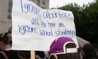 "Ignore abortions just like how you ignore school shootings" reads the sign. Abortion rights activists marched to the White House in Washington D.C. on July 9, 2022 to stage a mass sit-in. (Photo by Jeff Malet