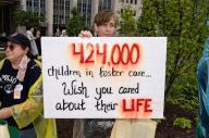 "424,000 children in foster care. Wish you cared about their life" reads her sign. Abortion rights activists marched to the White House in Washington D.C. on July 9, 2022 to stage a mass sit-in. (Photo by Jeff Malet