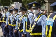 Police officers stand guard in front of demonstrators protesting against the state funeral for former Prime Minister Shinzo Abe near the venue in Tokyo, Japan, September 27, 2022. JIJI PRESS PHOTO / MORIO TAGA