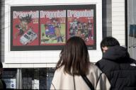 People walk past an electric bulletin board that displays images of Dragon Ball at Shinjuku entertainment district of Tokyo, March 11, 2024. World-renowned Japanese manga artist Akira Toriyama, known for works including "Dr. Slump" and "Dragon Ball," died of acute subdural hematoma on March 1. He was 68. JIJI PRESS PHOTO / MORIO TAGA