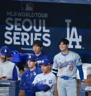 Two-way Japanese baseball star Shohei Ohtani, right, of the Los Angeles Dodgers and his interpreter, Ippei Mizuhara, back left, watch Major League Baseball