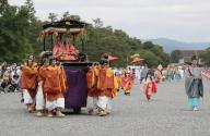 A procession of about 500 people dressed in elegant Heian Period (794-1185) costume parades during the Aoi Festival in Kyoto, western Japan, Wednesday, May 15, 2024. The Aoi Festival is one of the three major festivals of the ancient city. (Jiji Press/Hiroki Hata