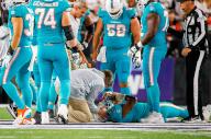 Miami Dolphins quarterback Tua Tagovailoa (1) is attended by medical staff after being sacked by Cincinnati Bengals defensive tackle Josh Tupou during the second quarter of an NFL football game at Paycor Stadium on Thursday, Sept. 29, 2022, in Cincinnati, Ohio. (David Santiago/Miami Herald/TNS