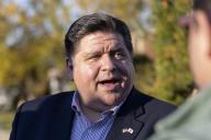 Illinois Gov. J.B. Pritzker greets constituents as he campaigns with Cook County Clerk Karen Yarbrough and Bellwood Mayor Andre Harvey on Tuesday, Nov. 1, 2022, in Bellwood, Ill., in Proviso Township. (Erin Hooley/Chicago Tribune/TNS