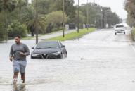 A stranded motorist walks away from his flooded car on North Mills Avenue after the high winds and rain from Hurricane Ian passed through Orlando, Fla., on Sept. 29, 2022. (Willie J. Allen Jr./Orlando Sentinel/TNS