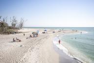 Beachgoers enjoy the sun at Blind Pass Beach on Sanibel Island on March 1, 2023. Recovery still continues six months after Hurricane Ian made landfall. (Patrick Connolly/Orlando Sentinel/TNS