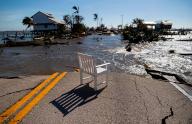 Gulf water flows through a broken section of Pine Island Road on Sept. 29, 2022, in Matlacha, Florida, after Hurricane Ian made landfall as a Category 4 storm, leaving areas affected with flooded streets, downed trees and scattered debris. (Matias J. Ocner/Miami Herald/TNS