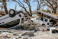 Damaged cars lay among the debris of homes destroyed by Hurricane Ian on Fort Myers Beach on Monday, Oct. 3, 2022. (Al Diaz/Miami Herald/TNS