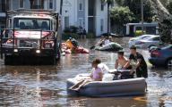 With Orange County Fire Rescue on the scene, residents of Arden Villas apartments use rubber boats, air mattresses and kiddie pools to float their belongings out of their homes on Sept. 30, 2022, after heavy rains from Hurricane Ian flooded the complex near the University of Central Florida. (Joe Burbank/Orlando Sentinel/TNS