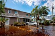 A house sits just above floodwaters off North Blackwater Lane during flooding due to Hurricane Ian at Stillwright Point in Key Largo, Florida, on Thursday, Sept. 29, 2022. (Daniel A. Varela/Miami Herald/TNS
