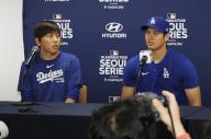 Shohei Ohtani (R) of the Los Angeles Dodgers and his interpreter Ippei Mizuhara attend a press conference in Seoul on March 16, 2024, prior to Major League Baseball