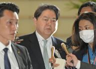 Japanese Chief Cabinet Secretary Yoshimasa Hayahi (C) meets the press at the premier