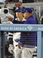 Shohei Ohtani (L) of the Los Angeles Dodgers has a conversation with manager Dave Roberts during a baseball game against the San Francisco Giants at Dodger Stadium in Los Angeles on April 1, 2024. (Kyodo) ==Kyodo