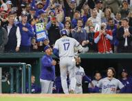 Shohei Ohtani (17) of the Los Angeles Dodgers is greeted by manager Dave Roberts (front L) in the dugout after hitting a solo home run in the ninth inning of a baseball game against the Washington Nationals at Nationals Park in Washington D.C. on April 23, 2024. (Kyodo) ==Kyodo