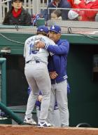Los Angeles Dodgers manager Dave Roberts hugs pitcher Yoshinobu Yamamoto after he pitches six-scoreless innings in a baseball game against the Washington Nationals on April 25, 2024, at Nationals Park in Washington. (Kyodo) ==Kyodo