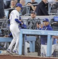 Los Angeles Dodgers manager Dave Roberts (R) applauds Yoshinobu Yamamoto as the pitcher returns to the dugout after pitching the eighth inning in a baseball game against the Miami Marlins at Dodger Stadium in Los Angeles on May 7, 2024. (Kyodo) ==Kyodo