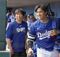 Shohei Ohtani (R) of the Los Angeles Dodgers and his then interpreter Ippei Mizuhara are pictured in Glendale, Arizona, on Feb. 27, 2024, as the team plays a spring training game against the Chicago White Sox. Mizuhara was fired in March and was charged in April with illegally transferring more than $16 million from one of Ohtani