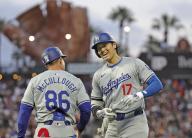 Shohei Ohtani (R) of the Los Angeles Dodgers smiles after hitting an RBI single in the fifth inning of a baseball game against the San Francisco Giants at Oracle Park in San Francisco on May 13, 2024. (Kyodo) ==Kyodo
