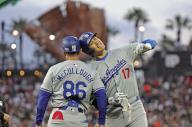 Shohei Ohtani (R) of the Los Angeles Dodgers touches helmets with first base coach Clayton McCullough after hitting an RBI single in the fifth inning of a baseball game against the San Francisco Giants at Oracle Park in San Francisco on May 13, 2024. (Kyodo) ==Kyodo