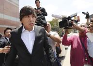 Ippei Mizuhara, the former interpreter for Los Angeles Dodgers star Shohei Ohtani, is surrounded by the media in front of a federal district court in Los Angeles on May 14, 2024, after attending a court hearing over two charges including bank fraud in connection with the theft of nearly $17 million of the two-way baseball player