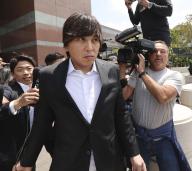 Ippei Mizuhara, the former interpreter for Los Angeles Dodgers star Shohei Ohtani, is surrounded by the media in front of a federal district court in Los Angeles on May 14, 2024, after attending a court hearing over two charges including bank fraud in connection with the theft of nearly $17 million of the two-way baseball player