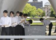 Hiroshima city officials take books listing the names of victims of the 1945 U.S. atomic bombing of the western Japanese city from a stone chamber at the Peace Memorial Park on May 15, 2024. A total of 125 books containing 339,227 names were aired out ahead of the rainy season. (Kyodo) ==Kyodo